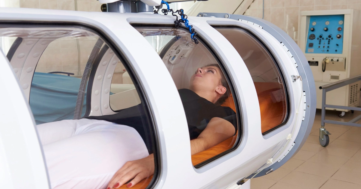A woman lying inside a hyperbaric oxygen therapy chamber in Kalispell, MT